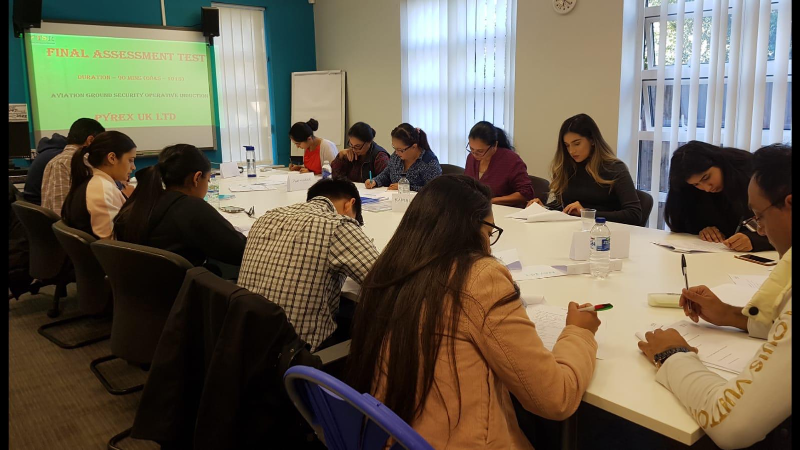 A Pyrex Ground Security Operative induction course under way, the projector showing the final assessment test